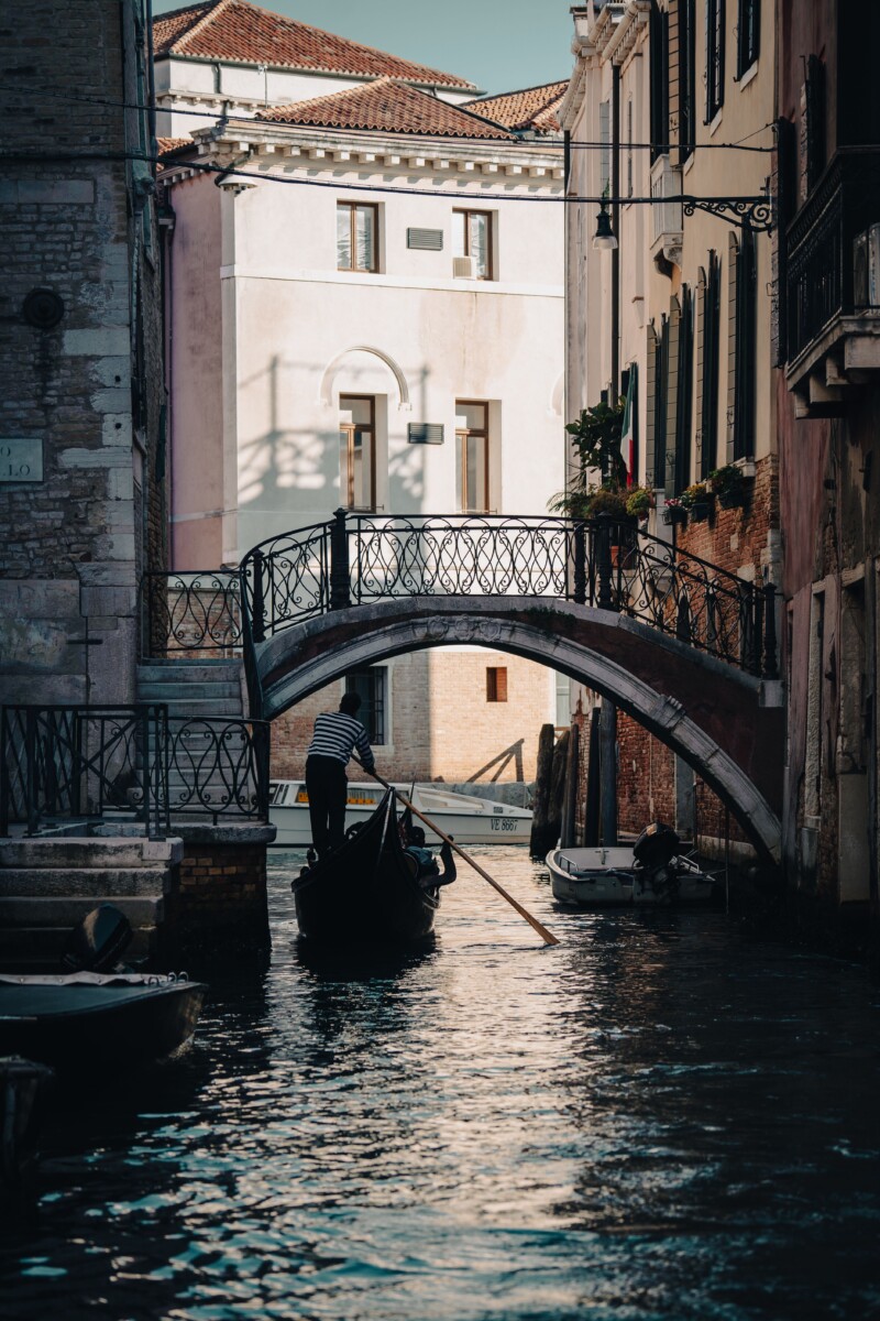 Góndola navegando bajo un puente en Venecia